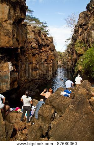 Unidentified tourists enjoying sunny day at Las Grietas in Santa Cruz, Galapagos Islands