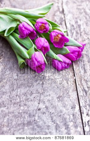 Bouquet Of Violet Tulips On The Oak Brawn Table