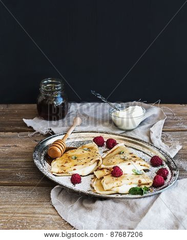 Thin Pancakes Or Crepes With Fresh Raspberry, Cream, Mint, On A