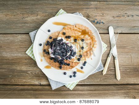 Dutch Waffles With Cream-cheese, Fresh Blueberry And Maple Syrup On A White Ceramic Plate Over A Rou