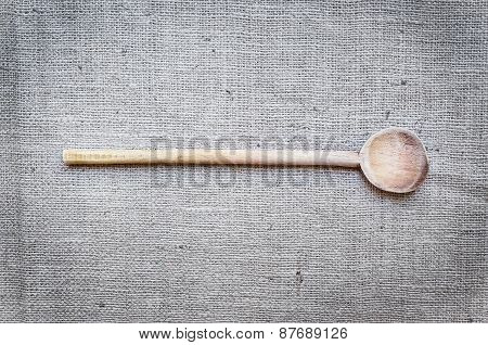 Rustic Wood Cooking Spoon On A Sackcloth Surface
