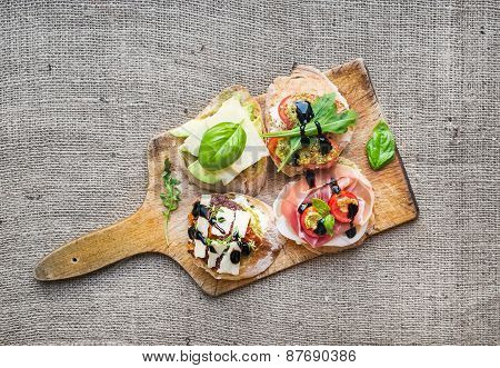 Brusquetta Set On A Rustic Wooden Board Over A Sackcloth Surface