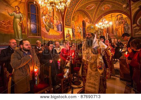 ATHENS, GREECE - APR 12, 2015: Unknown people during celebration of Orthodox Easter (Midnight Office of Pascha) Holy Saturday is often the only time that the Midnight Office will be read in parishes.