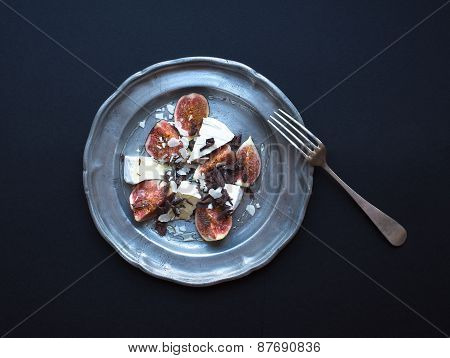 Dessert Consisting Of Fresh Figs And Brie Cheese With Honey, Almond Petals And Chocolate Chips On A