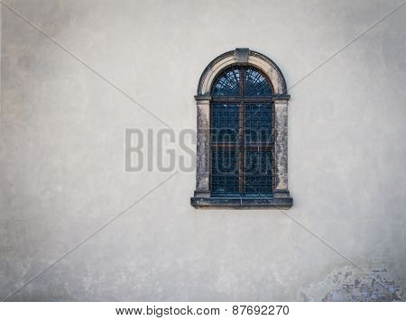 Antique Medieval Window With Iron Bars And Old White Wall