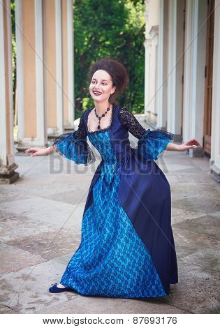 Beautiful Young Woman In Blue Medieval Dress Doing Curtsey