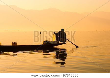 Three fishermen catches fish for food in sunrise in Inle Lake, Myanmar