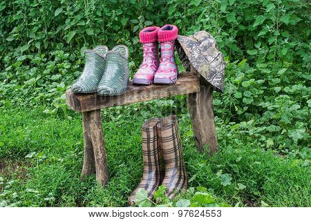 Rubber Shoes For Gardening And Hat Dried On The Bench