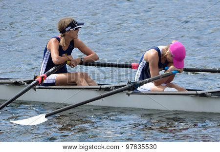 Exhausted lady scullers after finish of race.