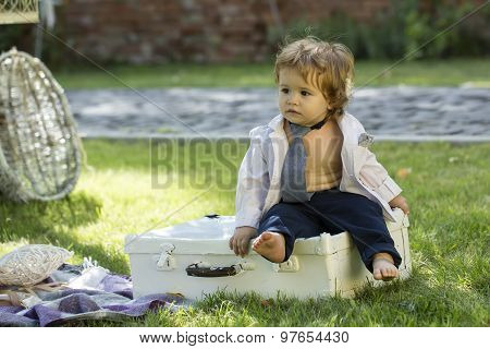 Baby Boy Sitting On Vintage Briefcase