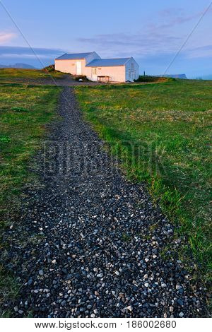 Small house of lighthouse keeper on Dyrholaey Nature Reserve, Iceland, Europe.