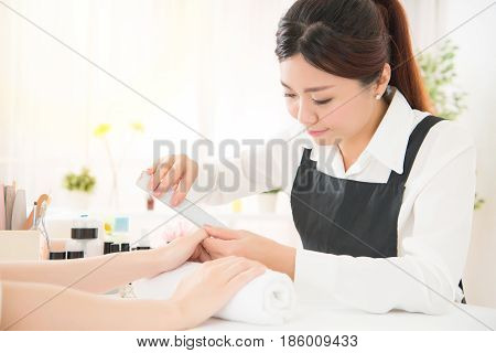 Manicurist Doing Nail Rub By Using Shiner
