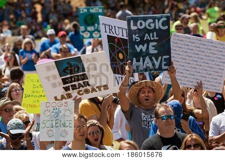 ATLANTA, GA - APRIL 22: Thousands of people crowd Candler Park and hold up signs as they take part in a rally preceding the Atlanta March for Science on Earth Day in Atlanta GA on April 22 2017.