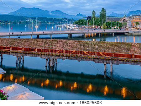Night view towards Chapel Bridge (Kapellbruecke) together with the octagonal tall tower (Wasserturm) it is one of the Lucerne's most famous tourists attraction