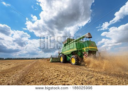 Dobrich Bulgaria - July 08: Modern John Deere combine harvesting grain in the field near the town Dobrich Bulgaria July 08 2016