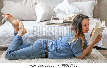 Girl Reading A Book In A Cozy Room