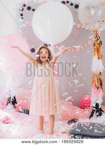 Beautiful little girl celebrating birthday party. Family celebration of the child