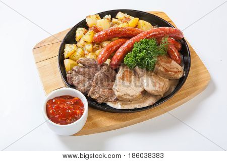 Grilled Sausages With Potatoes, And Roasted Meat On A Grill Pan
