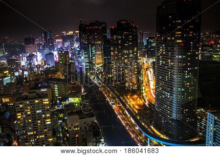 Aerial view over Tokyo cityscape and Shiodome skyscrapers and business offices view from Tokyo World Trade Center at night, Tokyo, Japan.