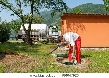 Worker Making Gas Supply On A Tank In The Garden
