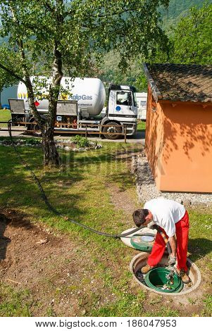 Worker Making Gas Supply On A Tank In The Garden