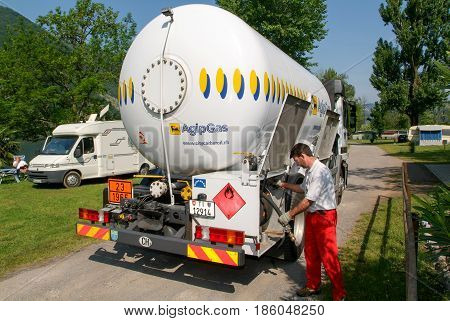 Melano Switzerland -20 May 2005: worker making gas supply on a tank in the garden of a house at Melano on Switzerland