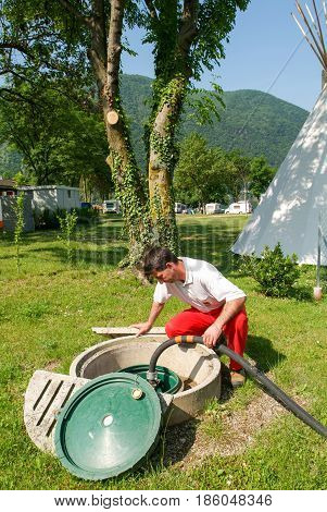 Worker Making Gas Supply On A Tank In The Garden