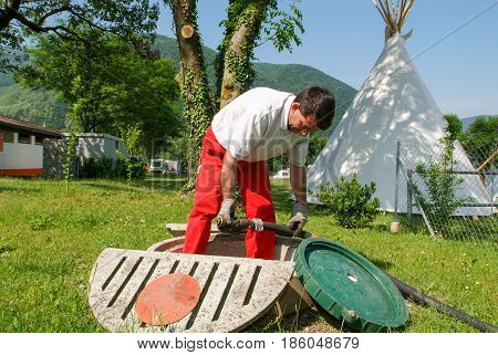 Worker Making Gas Supply On A Tank In The Garden