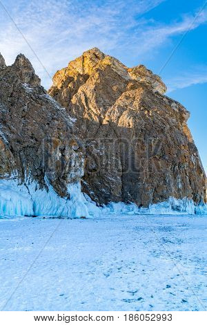 Famous Deva Rock with snow and icicles at northern Cape Khoboy in Frozen Lake Baikal Russia