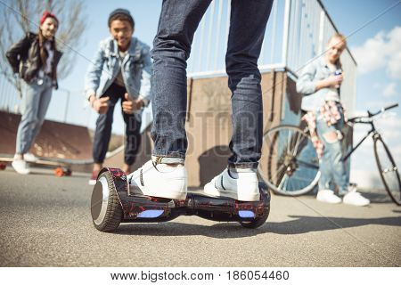 Stylish Hipster Boy Riding Gyroboard With Friends Near By, Teenagers Having Fun Concept