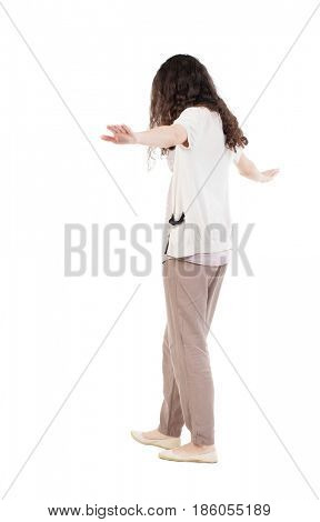 Back view woman is balancing on a tightrope.   Standing young girl in parka. Rear view people collection. Isolated over white background. The girl goes on a tightrope tightrope walker
