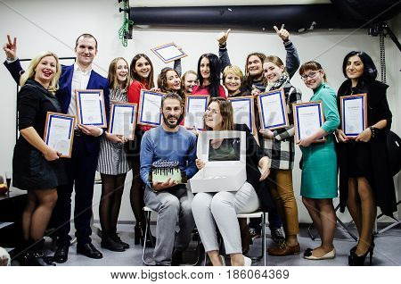 October 10 2016. Rostov-on-Don. Russia. Group of graduates of photo cources with teachers and a delicious festive cake