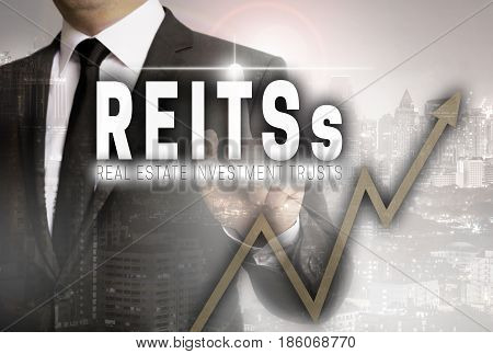 Reits is shown by businessman concept background