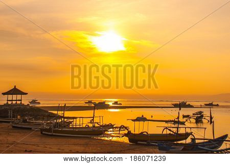 Traditional Balinese Boats And Pavilion In Sanur Beach In The Morning At Dawn, Bali, Indonesia.