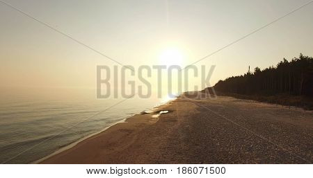 Sunrise of sun setting over Baltic sea on calm morning. Aerial shoot. Lubiatowo, Poland.