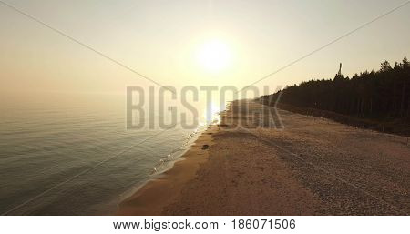Sunrise of sun setting over Baltic sea on calm morning. Aerial shoot. Lubiatowo, Poland.
