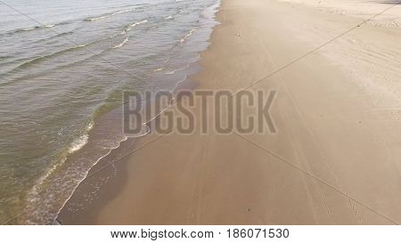 Aerial view of Baltic sea shore, waves and sandy beach. Lubiatowo, Poland