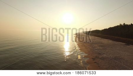Sunrise of sun setting over Baltic sea on calm morning. Aerial shoot. Lubiatowo, Poland.