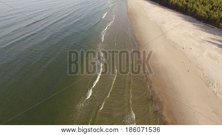 Aerial view of Baltic sea shore, waves and sandy beach. Lubiatowo, Poland