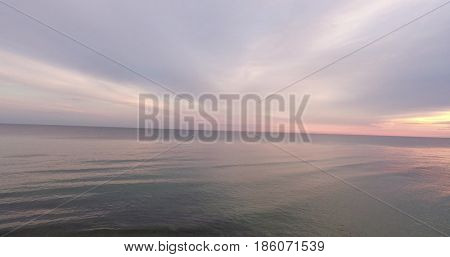 Sunrise of sun setting over Baltic sea on calm morning. Aerial shoot. Lubiatowo, Poland.