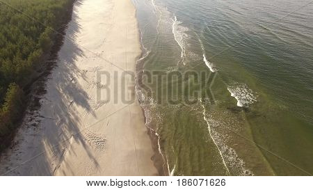 Aerial view of Baltic sea shore, waves and sandy beach. Lubiatowo, Poland