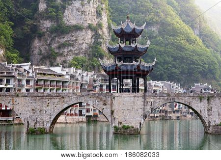 Ancient Pagoda at the bridge in ancient Zhenyuan town on Wuyang River in Guizhou Province, China