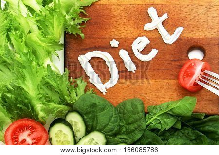Various Vegetables Lettuce Frize, Spinach And Vegetables Beautifully Laid Out Near Cutting Board Wit
