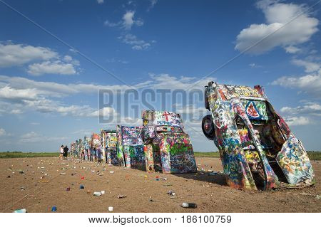 Amarillo Texas - July 8 2014: Row of brightly painted Cadillacs in the Cadillac Ranch in Amarillo Texas USA.