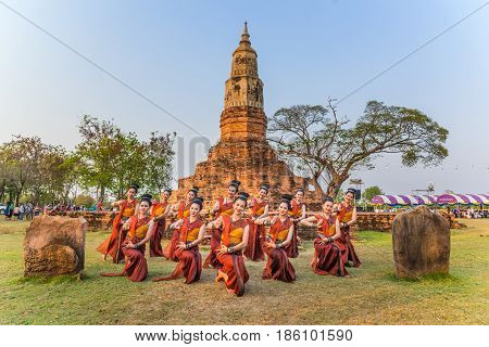 KALASIN THAILAND - FEBRUARY 20 2016: Girl dancers with local dress doing Thai Northeastern traditional dance at Yaku Pagoda to celebrate Buddism event in Kalasin