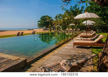 Sun Loungers And Parasols On The Beach, Pool. Bali, Indonesia, Tanjung Benoa. Nusa Dua.