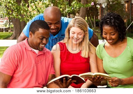 Small group of people talking and reading the Bible.