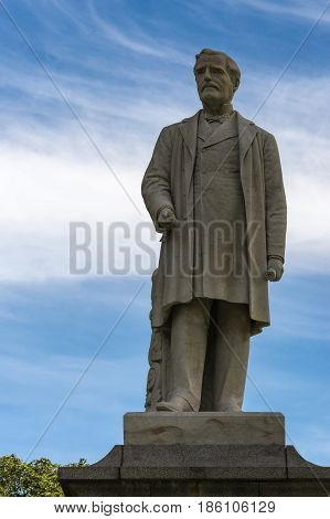 Auckland New Zealand - March 5 2017: Closeup of White stone statue of Sir George Grey in Albert Park under blue cloudy sky.