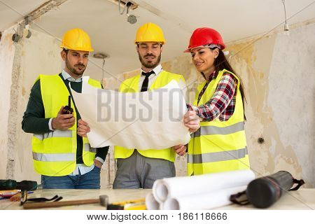 Three Arhitects Working Together On Construction Site Project