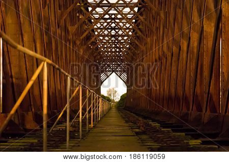 Old industrial railway railroad iron bridge center perspective night